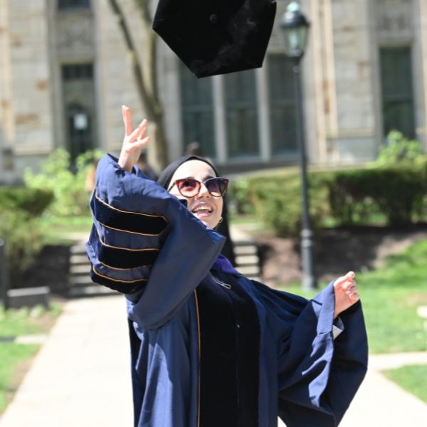 girl throwing up graduation hat