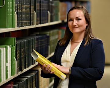  A law student gathers research at a library.