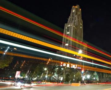 The Cathedral of Learning with laser lights in the foreground.